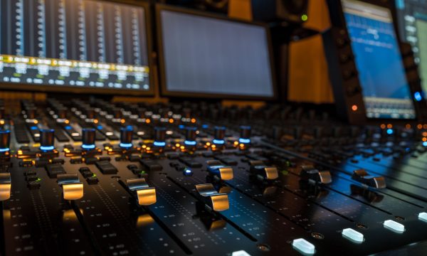 Closeup of sound mixing panel knobs and switches