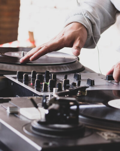 DJ playing music at a hip hop party. analog turntable, Dj uses turntable and mixer for scratching.