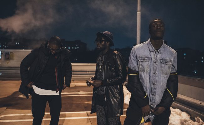 three young men posing outdoor looking camera serious - rap crew, gang, swag concept